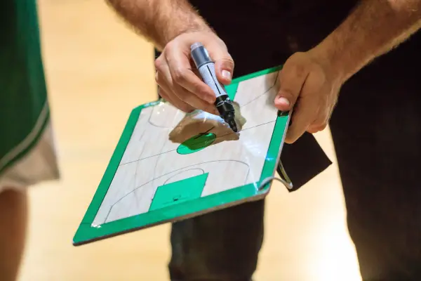 basketball-coach-with-clipboard-min.webp