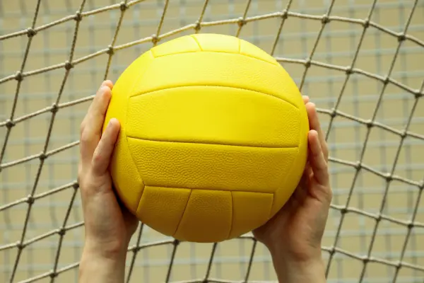 holding_yellow_volleyball-min.webp